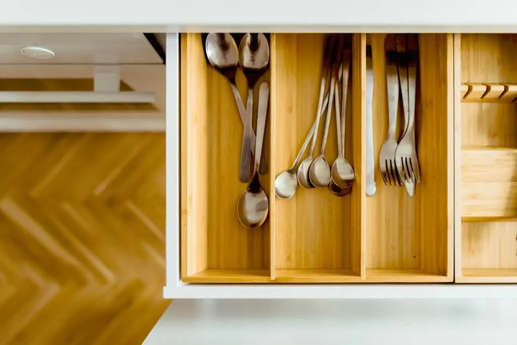 Declutter your kitchen: Organized silverware drawer with spoons and forks.