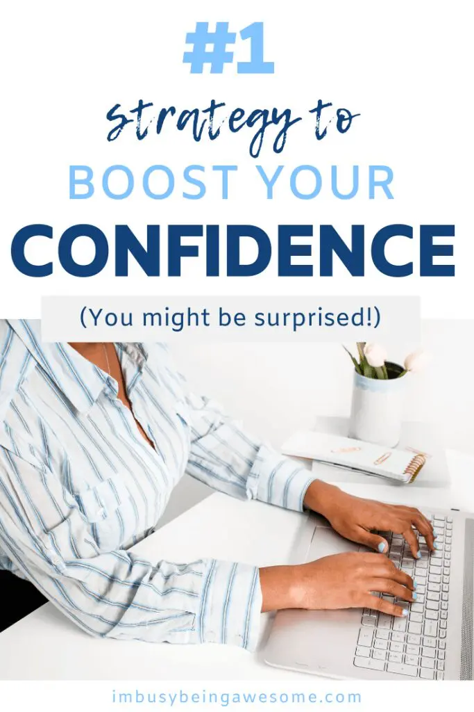 Woman typing on laptop, boosting confidence with a growth mindset.