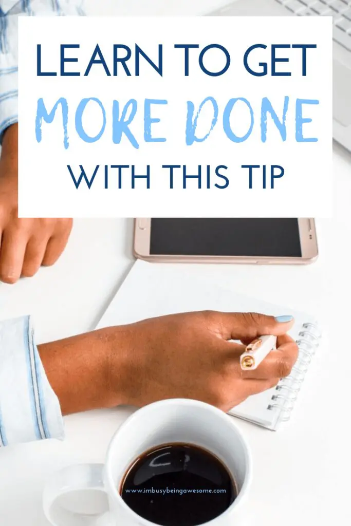 Person writing in a notebook with coffee and phone. Text: Learn to get more done with this tip.