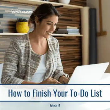 Woman smiling while working on her to-do list on a laptop.