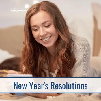 Woman writing New Year's Resolutions in a notebook.