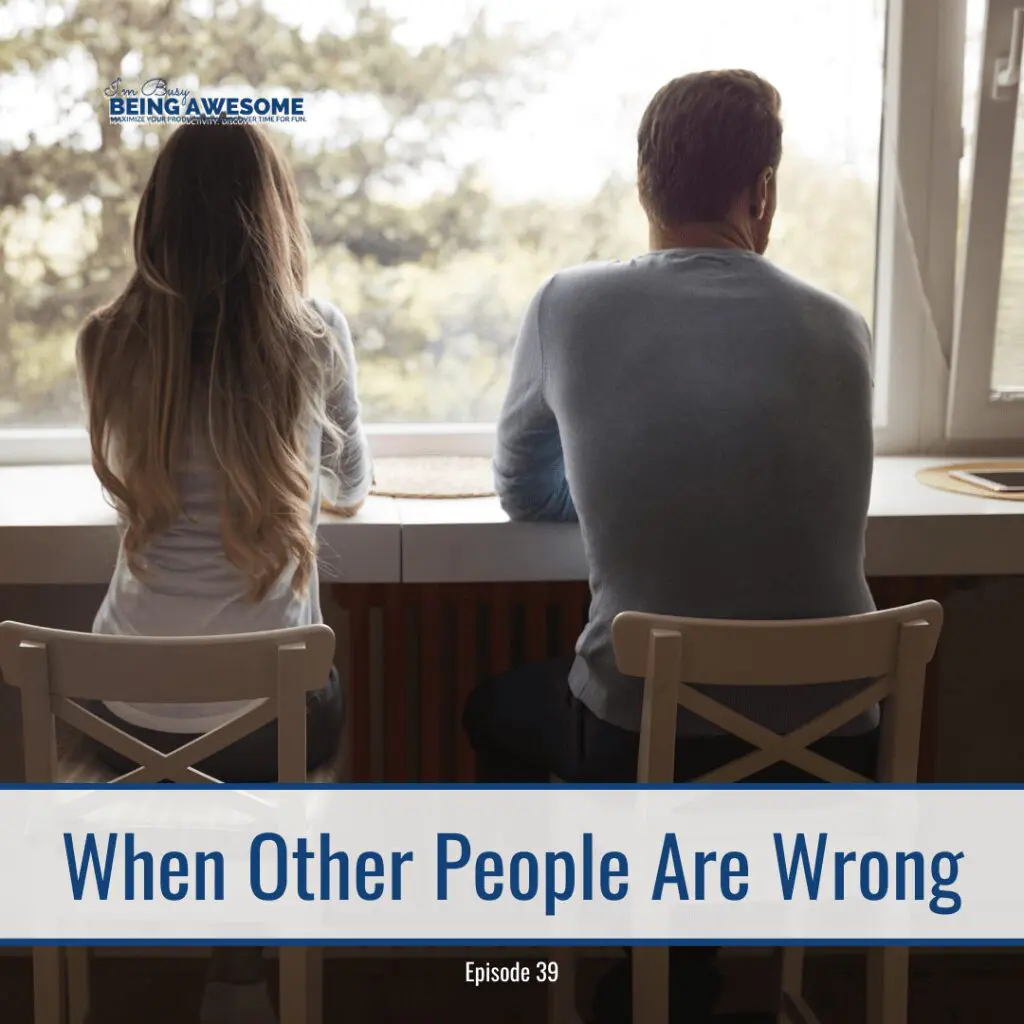 A couple sits apart, looking out the window, representing dealing with people who are wrong.