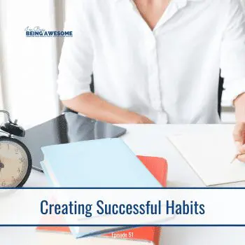 Creating successful habits: Desk with notebook, books, alarm clock, and tablet.
