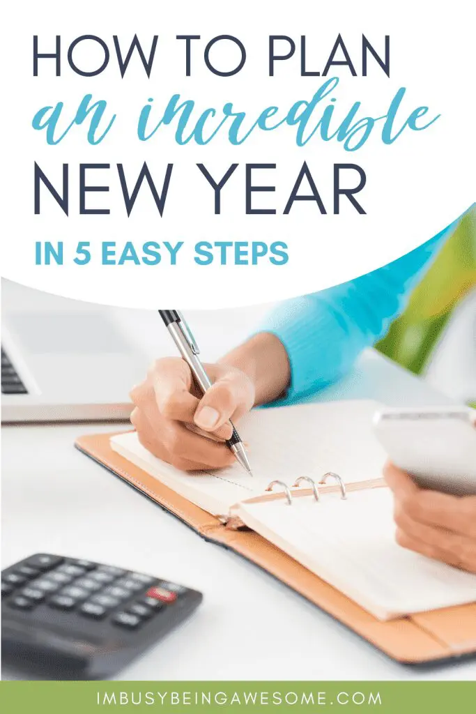 Planning for the New Year with notebook, pen, calculator, and phone.