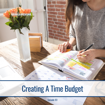 Woman planning her time budget in a calendar with sticky notes.