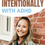 Image with text: "Use this strategy to live your year intentionally with ADHD." Woman smiling in front of brick wall.