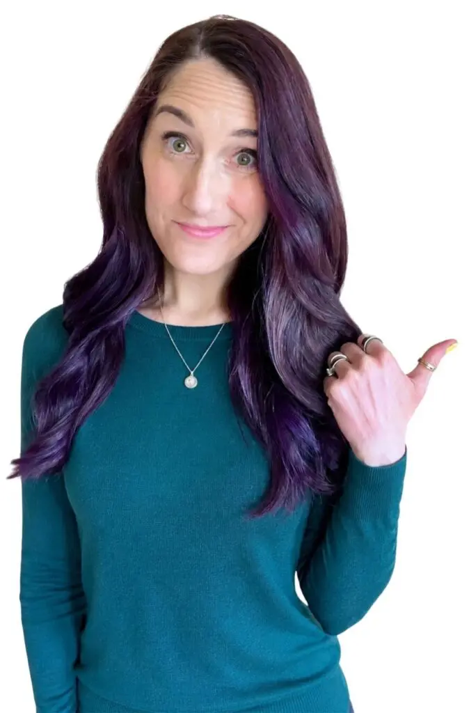Woman with purple hair gestures to the side, ready for Overwhelm to Action LIVE