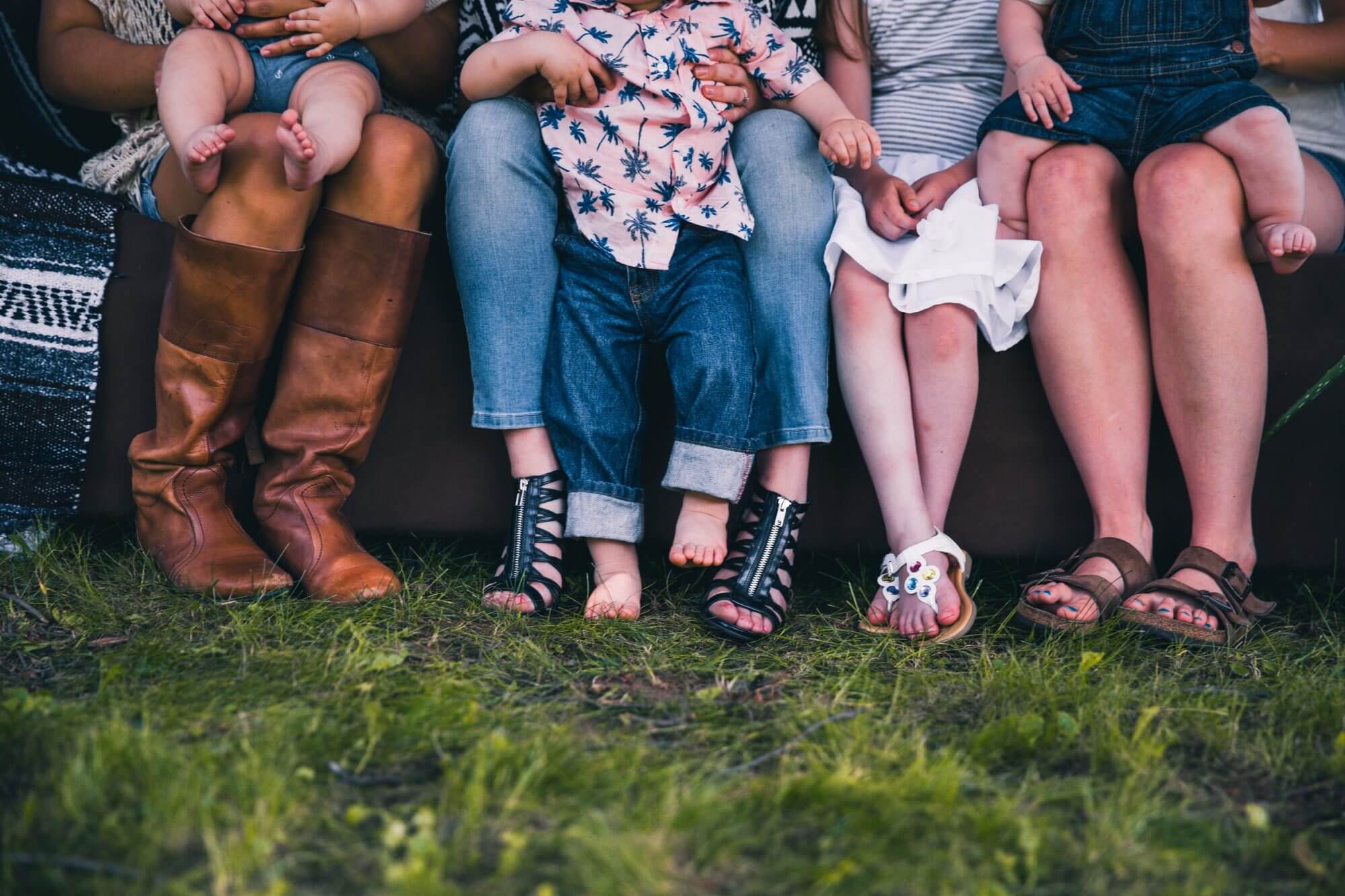 People sitting with children on their laps, family photo
