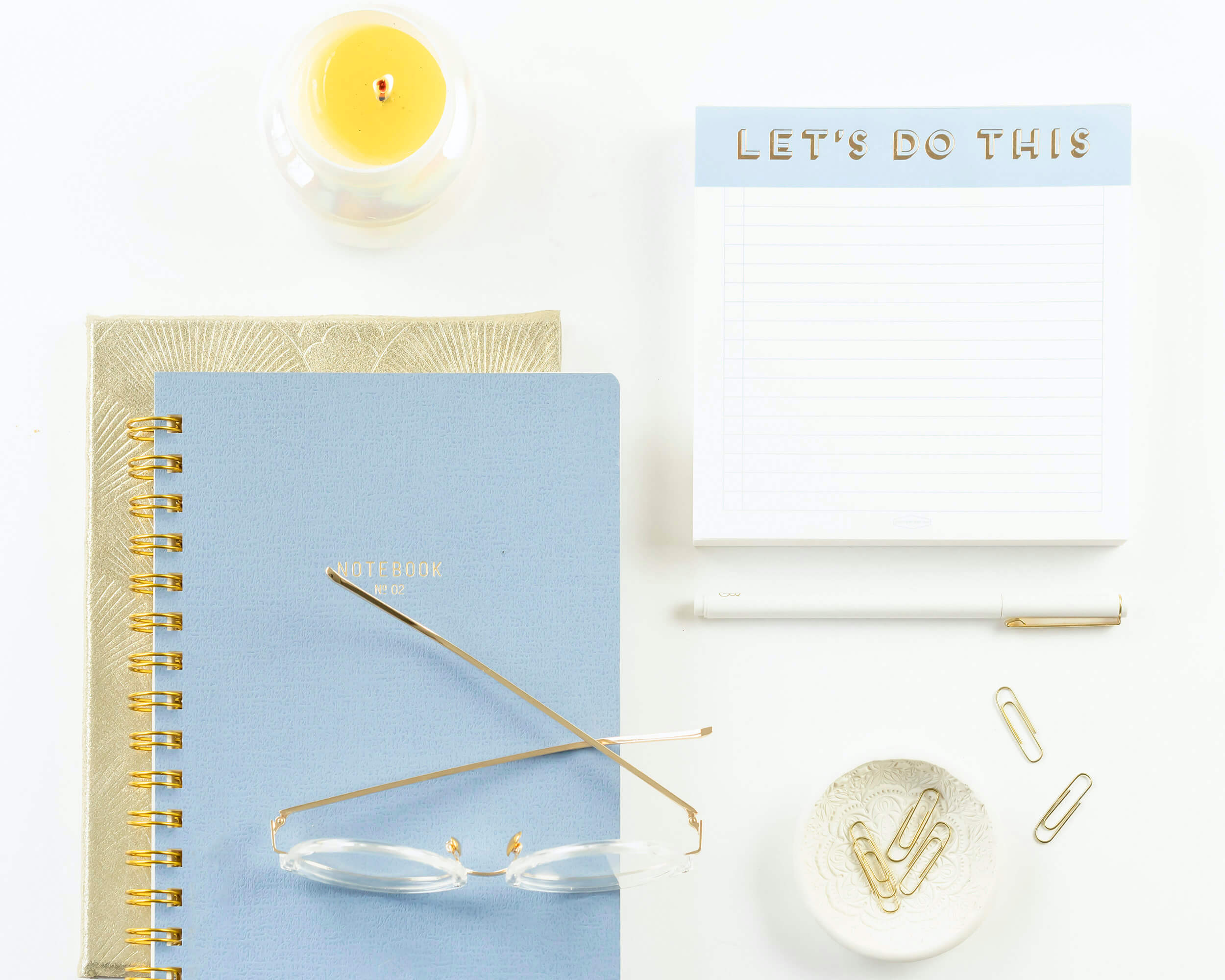 Notebook, glasses, and "Let's Do This" notepad for focus and concentration with ADHD.