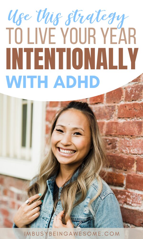 Image with text: "Use this strategy to live your year intentionally with ADHD." Woman smiling in front of brick wall.