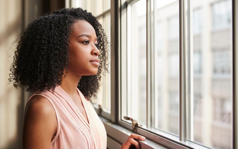 woman looking out window