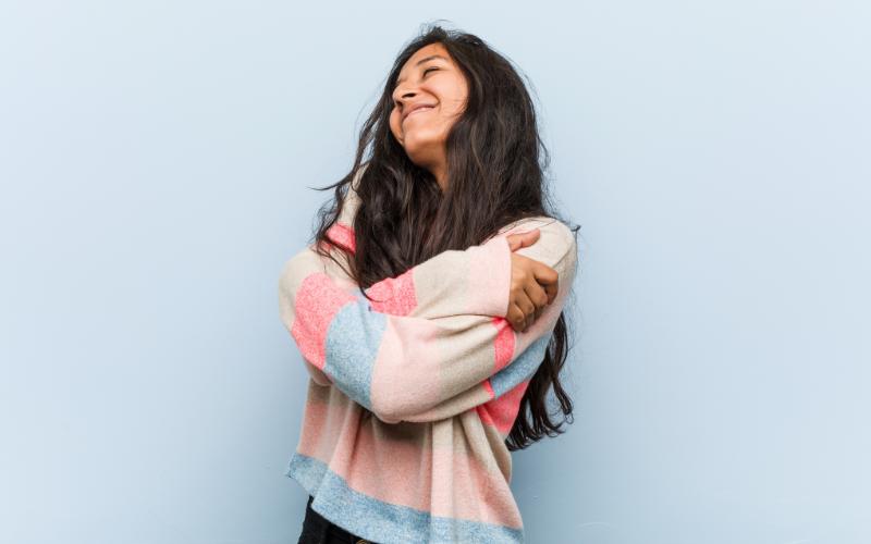 woman hugging herself