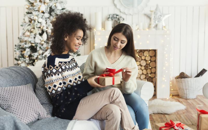women exchanging gifts at Christmas