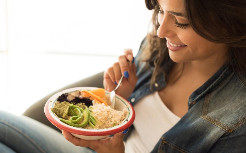 woman eating from bowl