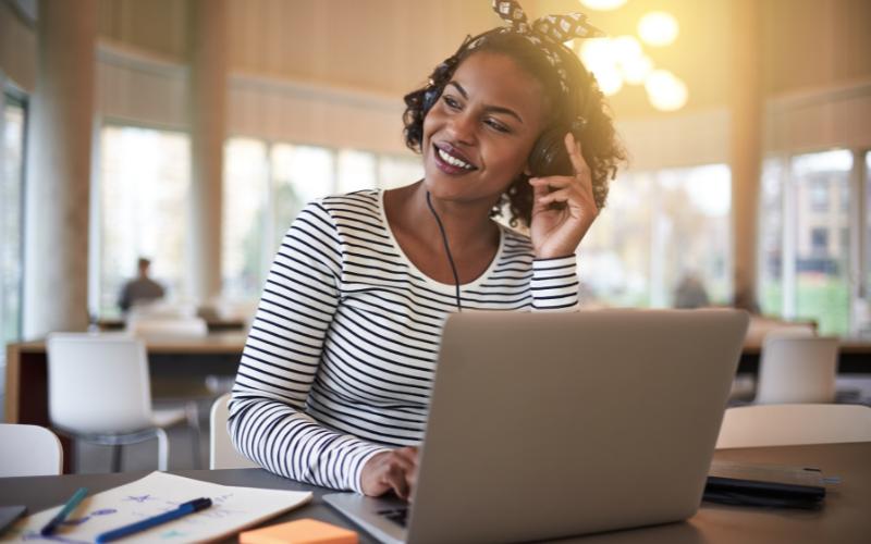 woman listening to music at laptop
