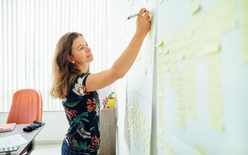 woman writing on board