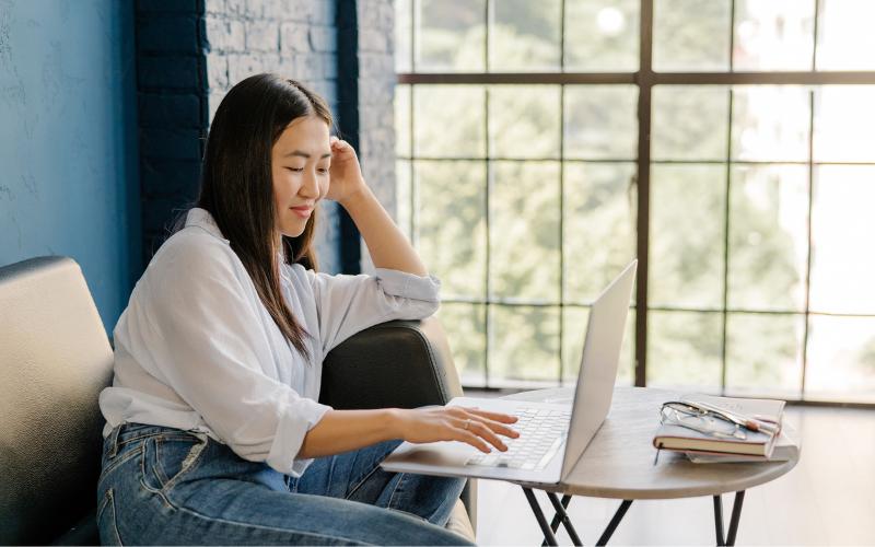 Woman using laptop for goal setting. ADHD blog.