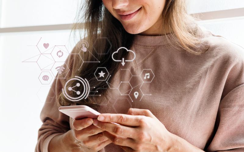 Woman using a phone with tech tools icons overlaid, possibly for ADHD management.