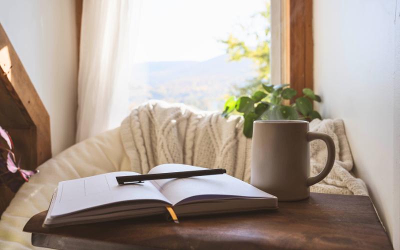 journal and mug in window