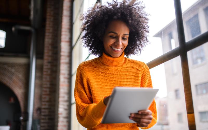 woman smiling looking at tablet