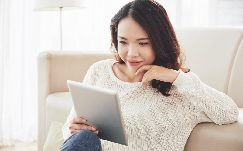 woman reading from tablet