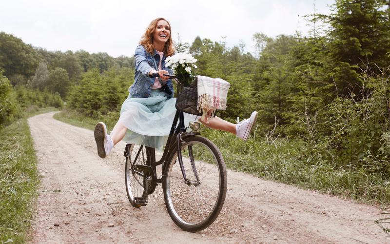 woman riding bike smiling