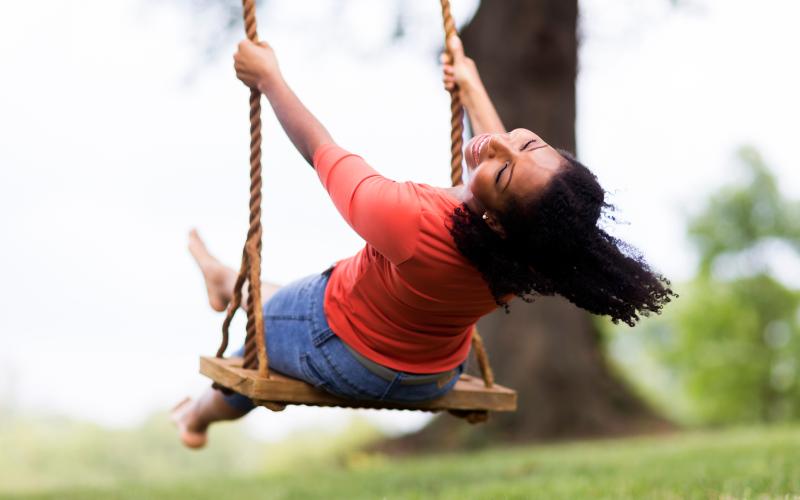 woman on swing set having fun laughing