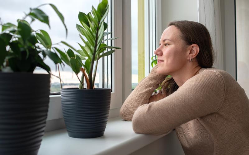 woman looking out window
