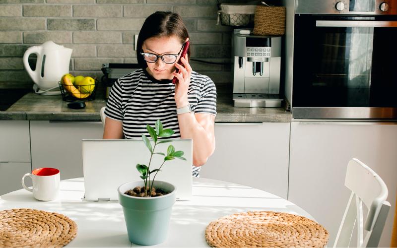woman working at table on laptop