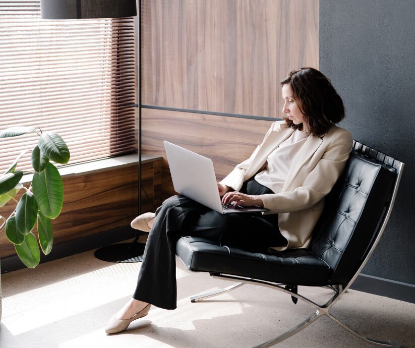 Woman working on laptop, pondering why is change so hard, especially with ADHD.