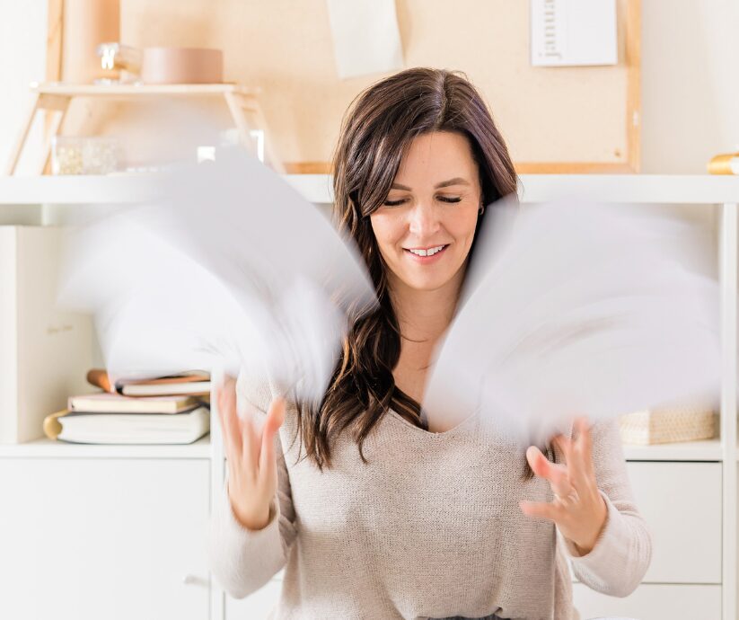 Woman overwhelmed by ADHD mindsets, tossing papers.